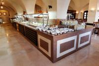 a buffet in a building with food on it at JAZ Makadina in Hurghada