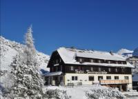 a large building with snow on the roof at Hotel Tauernpasshöhe in Obertauern