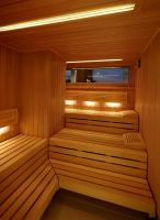 a sauna with two benches in a wooden room at AMERON Hamburg Hotel Speicherstadt in Hamburg