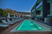 a swimming pool with lounge chairs next to a building at Del Mar &#39;Adults Only&#39; in Stalida
