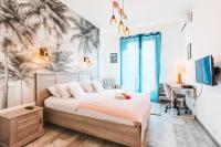 a bedroom with a bed with a desk and a palm tree mural at LE TIVOLI II AP4282 By Riviera Holiday Homes in Nice