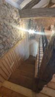 a spiral staircase in a building with a stone wall at Chateau Mano in Mairé-lʼEveseault