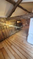 a large room with a wooden floor and a wall at Chateau Mano in Mairé-lʼEveseault