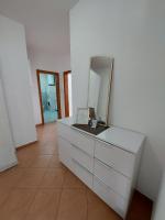 a white dresser with a mirror on top of it at Apartman Sany in Bihać