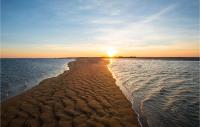 a beach with the sun setting over the water at 2 Bedroom Beautiful Home In La Faute-sur-mer in La Faute-sur-Mer