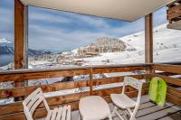 two chairs on a balcony with a view of a ski slope at appartement au pied des pistes in Orcières