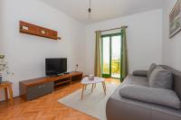 Televízia a/alebo spoločenská miestnosť v ubytovaní Apartments Kate