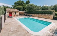 a swimming pool in a yard with a house at Gorgeous Home In Lioux With Wifi in Lioux