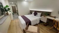 a bedroom with a large bed and a desk and chair at 海的墾丁旅店 Ocean KT Inn in Kenting