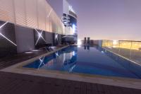 a swimming pool in the middle of a building at Treppan Hotel & Suites By Fakhruddin in Dubai