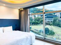 a bedroom with a bed and a large window at Spa Spring Resort in Taipei