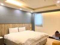 a bedroom with a bed and a large window at Spa Spring Resort in Taipei