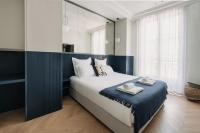 a bedroom with a large bed with two towels on it at HIGHSTAY - Luxury Serviced Apartments - Le Marais in Paris