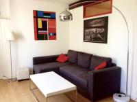 a living room with a couch and a table at 2 pièces hyper centre de La Rochelle, proche du port et de la plage in La Rochelle