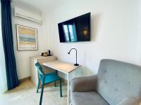 a room with a desk and a chair and a tv at Hotel Apartamentos Marina Luz in Chipiona