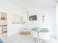 a white kitchen with a table and two chairs at Appartement La Jarne, 2 pièces, 4 personnes - FR-1-535-35 in La Jarne