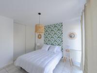 a white bedroom with a white bed and a mirror at Appartement La Jarne, 2 pièces, 4 personnes - FR-1-535-35 in La Jarne