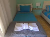 A bed or beds in a room at Seaside Apartment in Xilokastro - Thalassa Blue by Booking Kottas