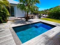a swimming pool in a backyard with a wooden deck at Nice 2 bed-rooms villa at Saint Barth in Saint Barthelemy