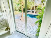 a sliding glass door with a view of a swimming pool at Nice 2 bed-rooms villa at Saint Barth in Saint Barthelemy