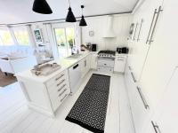 a kitchen with white cabinets and a black and white rug at Nice 2 bed-rooms villa at Saint Barth in Saint Barthelemy