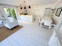 a kitchen and living room with white furniture and a table at Nice 2 bed-rooms villa at Saint Barth in Saint Barthelemy