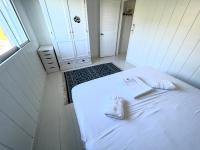 a white room with a bed with two pillows on it at Nice 2 bed-rooms villa at Saint Barth in Saint Barthelemy