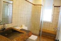 a bathroom with a stone sink and a shower at 微笑58民宿 Smile 58 B&amp;B in Puli
