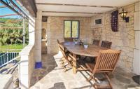 a patio with a wooden table and chairs at Awesome Home In Bessges With Wifi in Bessèges