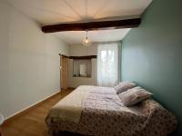 a bedroom with a bed and a window at Le Georges V in Alzonne