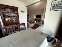 a view of a living room with a table and a dining room at Une terrasse sur Monaco logement 2 chambre in Beausoleil