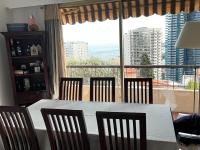 a dining room with a table and chairs and a large window at Une terrasse sur Monaco logement 2 chambre in Beausoleil