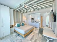 a bedroom with a bed and a desk and a television at Hotel Apartamentos Marina Luz in Chipiona