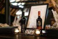 two bottles of wine sitting on a table with candles at Ai Aiba - The Rock Painting Lodge in Omaruru