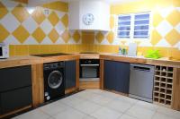 a kitchen with a washer and dryer at Acajou in Sainte-Luce