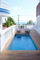 a swimming pool on the balcony of a house at Acajou in Sainte-Luce