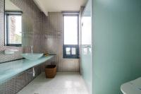 a bathroom with a sink and a glass shower at Cingjing Florence Resort Villa in Ren&#39;ai