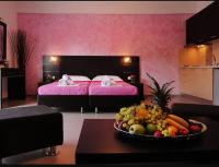 a room with a bed and a bowl of fruit on a table at Dafni studios in Parga