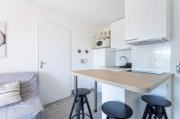 a small kitchen with a table and two stools at Cosy Apt Of 25 M Near The City View On Sea in La Seyne-sur-Mer