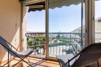 two chairs on a balcony with a view of a city at Cosy Apt Of 25 M Near The City View On Sea in La Seyne-sur-Mer