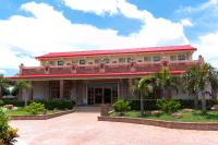 a large building with palm trees in front of it at Family Pottery in Hengchun South Gate