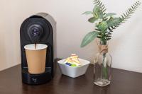 a coffee machine sitting on a table with a drink at Hôtel Le Florin in Rennes