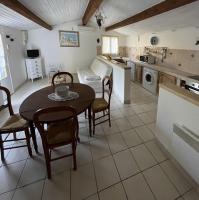 a kitchen and dining room with a table and chairs at Gîte en Drôme provençale in Les Granges-Gontardes
