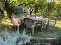 a table and chairs in a yard with a table and chairs at Gîte en Drôme provençale in Les Granges-Gontardes