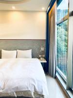 a bedroom with a large bed and a window at Spa Spring Resort in Taipei