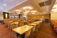 a dining room filled with tables and chairs at Rosen Inn International Near The Parks in Orlando