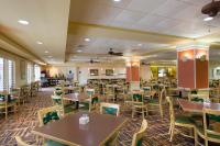 a dining room with tables and chairs at Rosen Inn Closest to Universal in Orlando