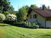 a house with a bunch of flowers in front of a yard at Gîte Anould, 4 pièces, 6 personnes - FR-1-589-2 in Anould