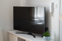 Televízia a/alebo spoločenská miestnosť v ubytovaní Biztos Kuckó
