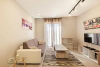 a living room with a couch and a tv at Brand new 1BR in central MALTA-Hosted by Sweetstay in Tal-Pietà